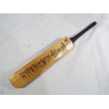 Cricket - a miniature cricket bat bearing the marks Keith Miller autograph Australians 1948 bearing