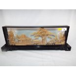 A good quality Diorama with carved cork depictions of a Japanese scene in glass display 20 cm x 56