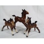 Beswick Pottery - a group of three foals finished in green gloss