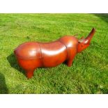 A brown leather footstool (or similar) depicting a rhinoceros, unused,