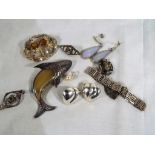 A collection of silver jewellery to include; brooches,