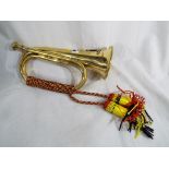 A yellow metal bugle displaying an army crest Est £20 - £40