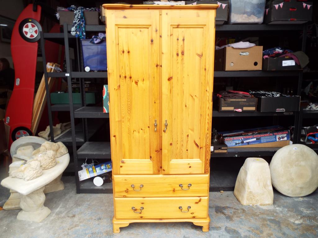 A pine wardrobe with two lower drawers 180cm x 82cm x 53cm