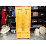 A pine wardrobe with two lower drawers 180cm x 82cm x 53cm