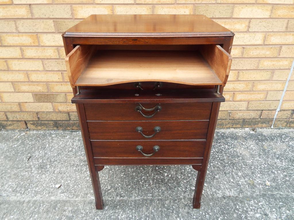 An Edwardian mahogany music cabinet of rectangular form with five fall front drawers