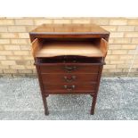 An Edwardian mahogany music cabinet of rectangular form with five fall front drawers