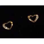 A pair of 9 carat gold 10 pt diamond set heart shaped earrings, approx weight 0.