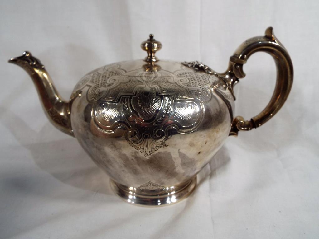 A Victorian hallmarked silver teapot with decorative etching, London assay 1840,