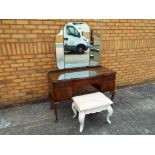 An early to mid 20th century triple mirror dressing table raised on cabriole supports, and a stool,