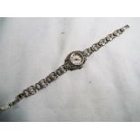 A lady's silver wristwatch set with marquisette throughout and a mother of pearl fascia,