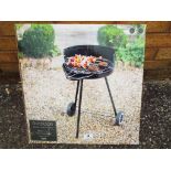 A new and unused outdoor round charcoal barbecue, boxed.