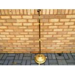 A brass standard lamp with twin socket,