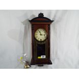 A dark wood cased wall clock marked to the cream dial 31 Day, floral garland design, Roman numerals,