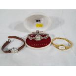 A lady's 15 jewel Ingersoll wristwatch set with marcasite with original box and a further two