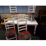 A good quality dining table and six chairs painted white,