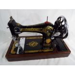A good quality wooden cased Singer sewing machine