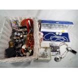 A basket containing a collection of good quality costume jewellery to include watches,