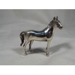 A white metal miniature figure in the style of a mare, stamped .