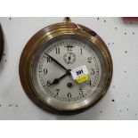 A Ship's dial clock on wooden mount, the brass case with removable brass bezel,