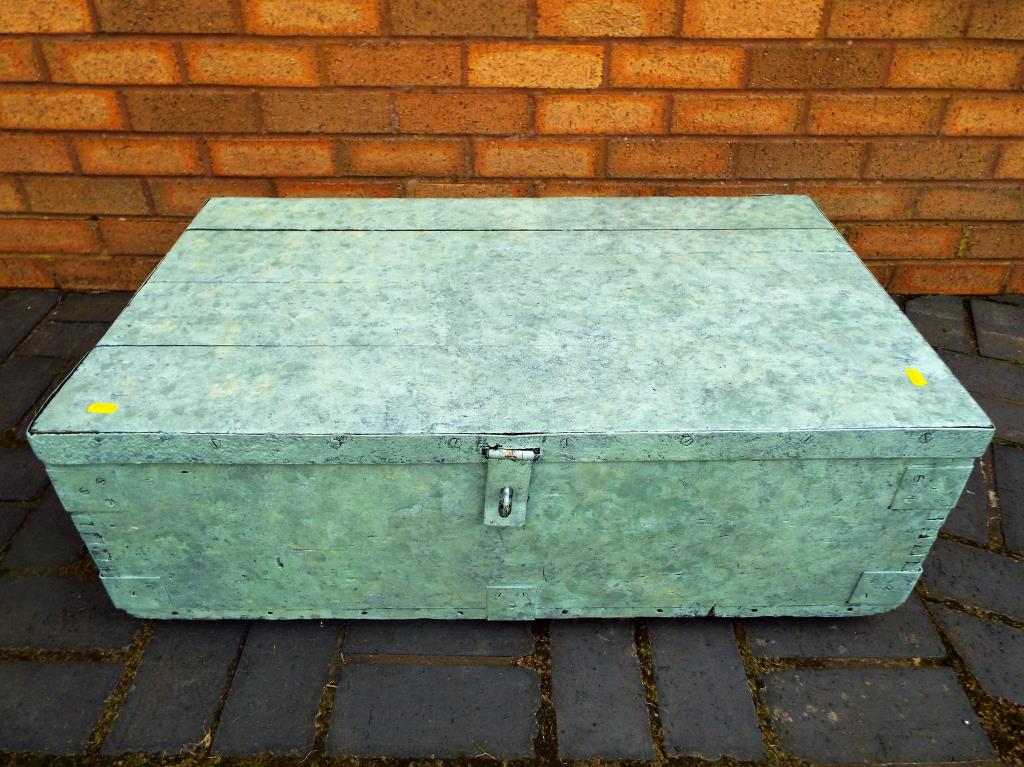 An ammunition box painted green,