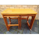 A retro nest of three tables with flip top, supported on castors,