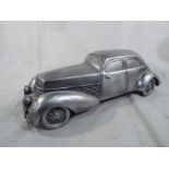 A model depicting a silver coloured vintage saloon car,