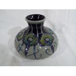 Moorcroft Pottery - a large modern spot vase decorated in shades of blue and green on a grey ground