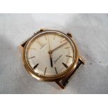 A gentleman's Omega Seamaster wristwatch, yellow metal case, baton indicators to the dial,