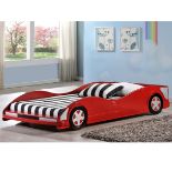 A single bed in the form of a racing car with red faux leather finish,