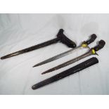 Two Malayan Kris with carved figural grips and carved wooden sheaths,