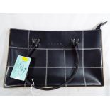 A good quality lady's handbag, black with tags marked Prada 23 cm x 37.