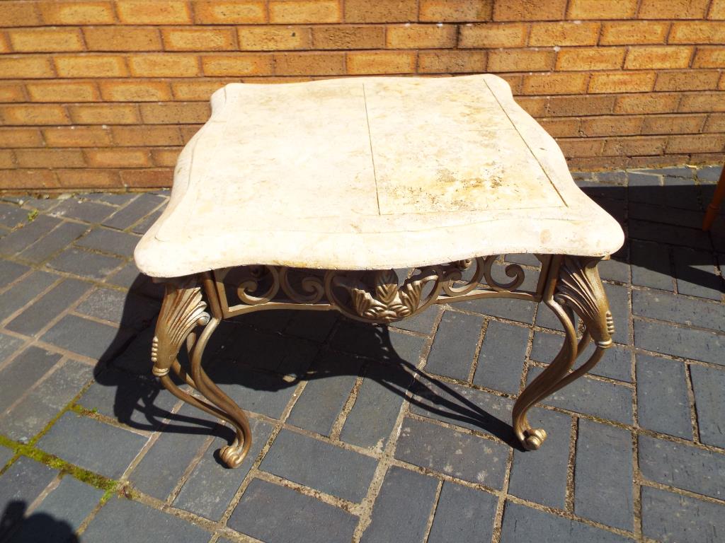 A faux marble topped side table on ornate pierced supports,