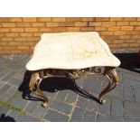 A faux marble topped side table on ornate pierced supports,