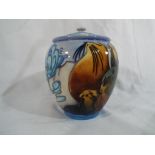 Moorcroft Pottery - a lidded container decorated with images of seals and waves,