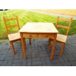 A good quality compact pine kitchen furniture set comprising a table,