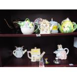 A quantity of ceramic novelty teapots and miniature cups and saucers to include Mary Ann Baker,