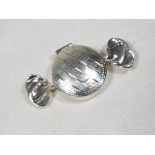A white metal pill box in the style of a wrapped sweet, stamped Sterling,