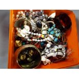 A large quantity of unsorted costume jewellery to include bracelets, necklaces,