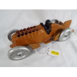 A cast iron model depicting a Hubley racing car with moveable pistons and driver,