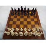 A complete weighted chess set with wooden board,