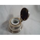 An Edward VII hallmarked silver capstan inkwell with ceramic liner and tortoiseshell lid,