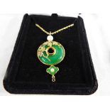 A lady's gilded silver necklace and pendant set with jade,