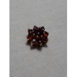 A lady’s hallmarked 9ct gold garnet cluster pendant, approx. weight 0.50 grams.