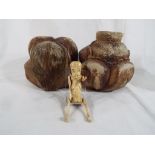 Two carved wooden figures depicting Buddhas and a novelty bone figure with jointed limbs (2)