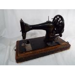 A good quality oak cased Singer sewing machine