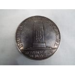 An Armistice Medallion - a white metal 10th Anniversary medallion,