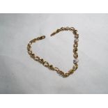 A lady's 9 carat yellow gold bracelet set with 5pt diamond hearts, approx weight 3.