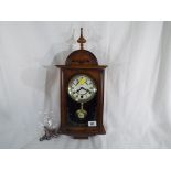 A dark wood cased wall clock marked to the white dial 31 Day and Legend, Roman numerals,