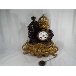 A French spelter clock c1900 depicting a young man in period dress with an agricultural theme with