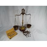 An early 20th century weighing balance with two sets of weights
